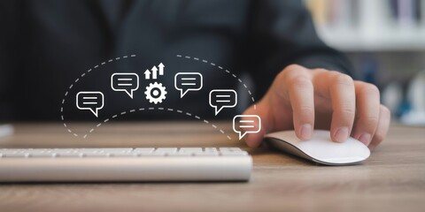 Digital Communication in the Workplace: A close-up shot captures a person's hand using a computer mouse, symbolizing digital interactions. Symbolic icons of speech bubbles and gears overlay.