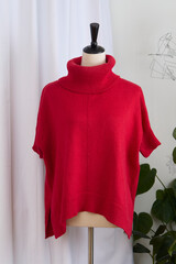 Knit red wool sweater on a mannequin