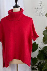 Knit red wool sweater on a mannequin