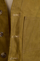 Waxed canvas vest in military green on a mannequin