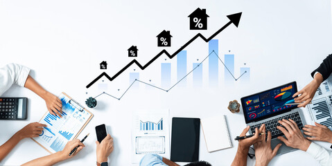 A collaborative workspace depicting professionals analyzing real estate market trends using various digital tools and charts to make informed decisions. Gantry
