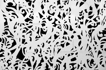 an abstract black and white pattern composed of swirling, organic shapes, laser-cut metal screens, fences, and various forms of artwork © Roberto Sorin
