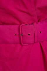 Pink belted dress in 1980s style on a mannequin