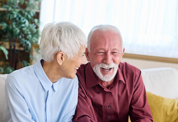 Portrait of senior couple having fun playing video games at home