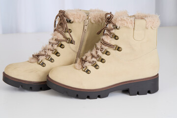 Tan boots on a white background