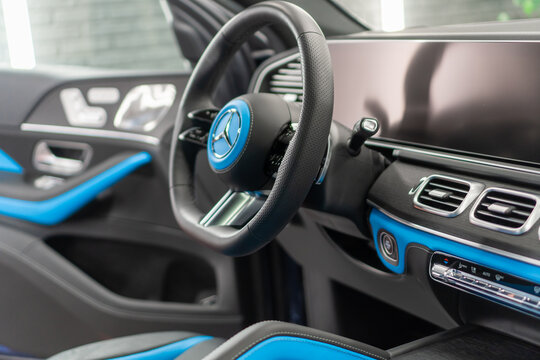 Mercedes-Benz GLE Coupe 53 AMG II C167 - Black and blue leather interior details, steering wheel, badge, front seats, central console panel, shift knob, dashboard. German SUV car. 