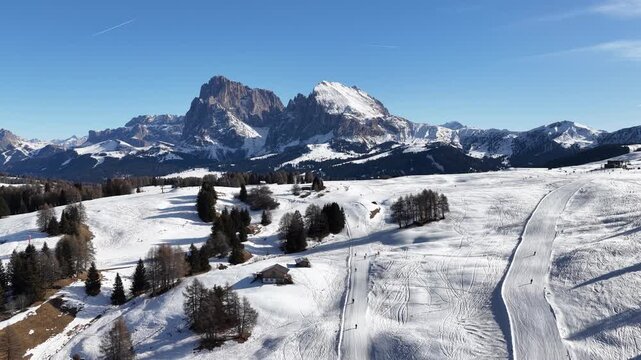 Ski slopes in Dolomites Italy Seiser Alm Blue Skies Aerial Drone Footage 4k snowboarding