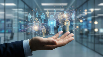 A hand supports a digital network of people icons in a modern office setting. This visual highlights themes of collaboration, technology, and social networking in the workplace