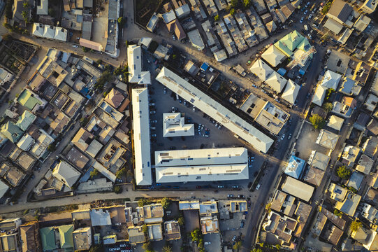 Aerial view of light bouncing off rooftops and roads surrounding the Tarauni Market, Kano, Kano, Nigeria.