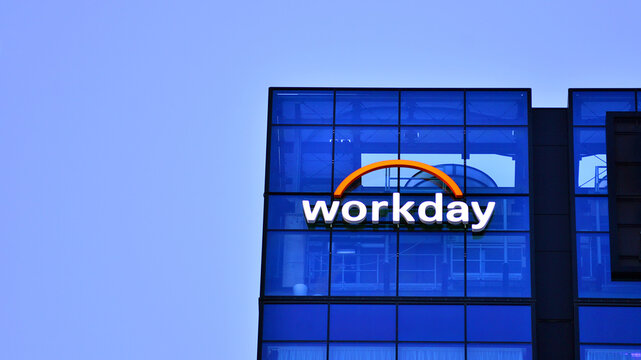 Warsaw, Poland. 21 January 2026. Urban landscape after dark. Neon sign with the inscription: Workday.