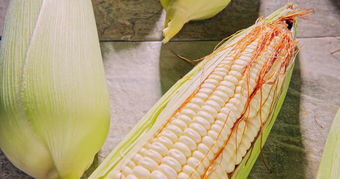 Overhead view, tour view of Creole corn cobs on a natural surface.