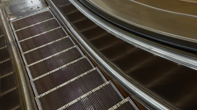 First person view of close up footage of moving empty modern escalator stairs, Russia, St. Petersburg