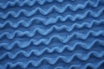 Blue swimwear fabric texture background Close-up texture of blue elastic swimwear fabric with wavy...