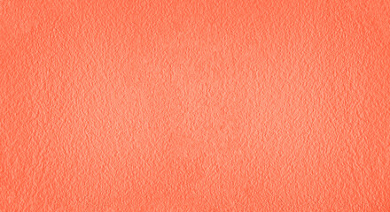 Fototapeta premium Textured background. Decorative plaster wall, external of facade. Texture of red pink peach fuzz stucco plaster wall of clay house structure background. Brown yellow clay mud cement texture pattern