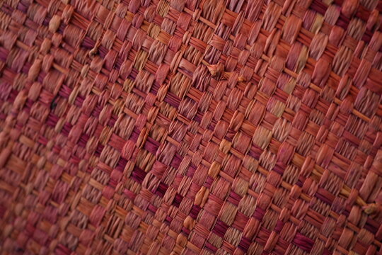 Red pink woven raffia straw texture background
