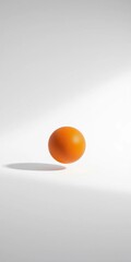 A singular orange orb hovers against a stark white expanse, its textured surface catching subtle studio light, basketball,  equipment