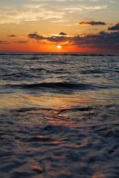 Sun rising over the horizon at sea in a beach at the Riviera Maya