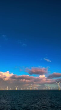 Calm ocean with wind turbines at dusk, Distant horizon showcasing offshore wind farms during sunset