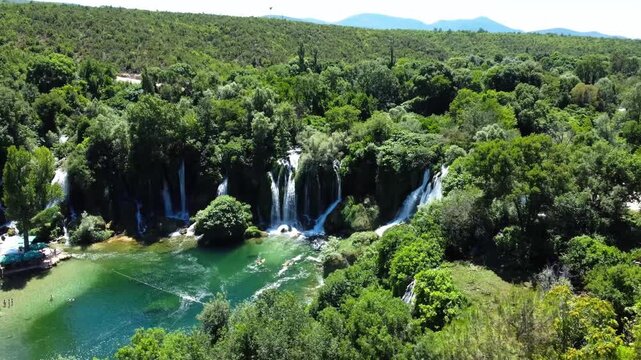 Wide aerial panorama of Kravice Waterfalls natural amhitheater in summer