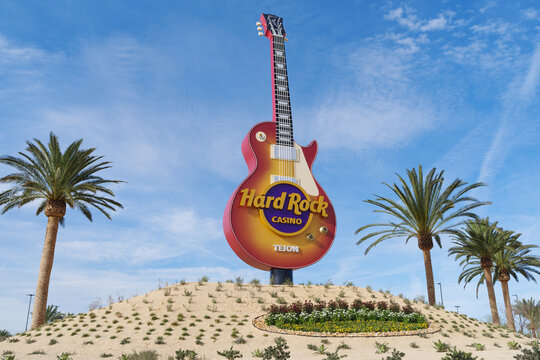 Hard Rock Cafe Tejon guitar sign with palm trees against a clear blue sky in Tejon, California, January 2, 2026.	
