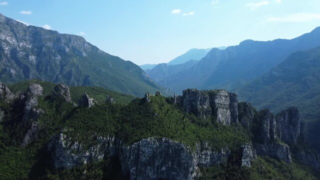 Cinematic aerial view of sharp jagged limestone mountin peaks