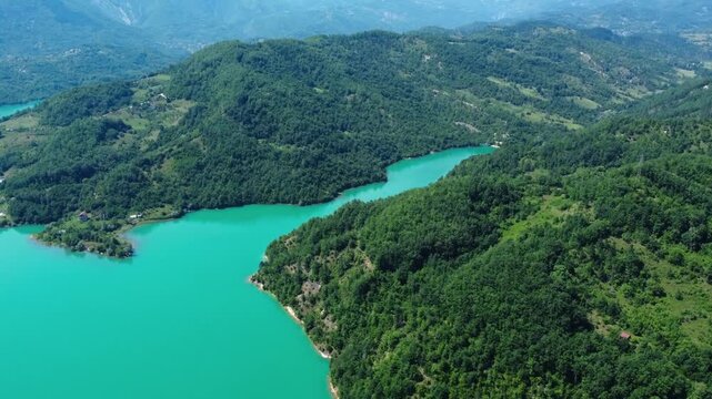 Aerial view of winding turquoise lake reservoir in gren mountains