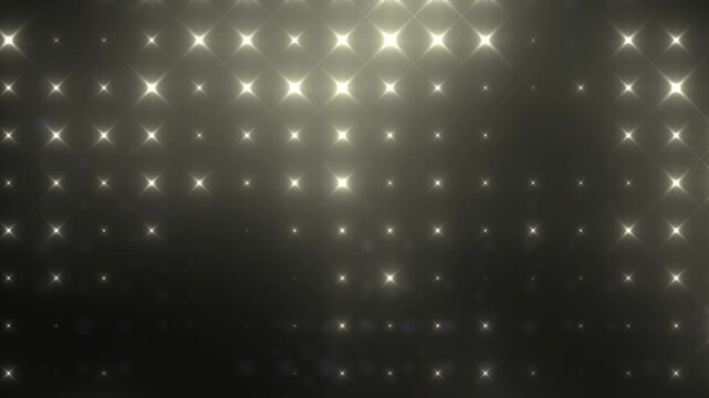 Abstract dark background with soft golden star-like light flares