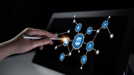A close-up view of a hand using a stylus on a touchscreen, showcasing a digital interface with various technology symbols representing modern connectivity and innovation. Tessel