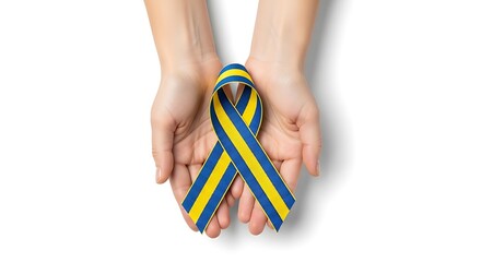 Two hands cradle a blue and yellow ribbon bow, symbolizing support and awareness