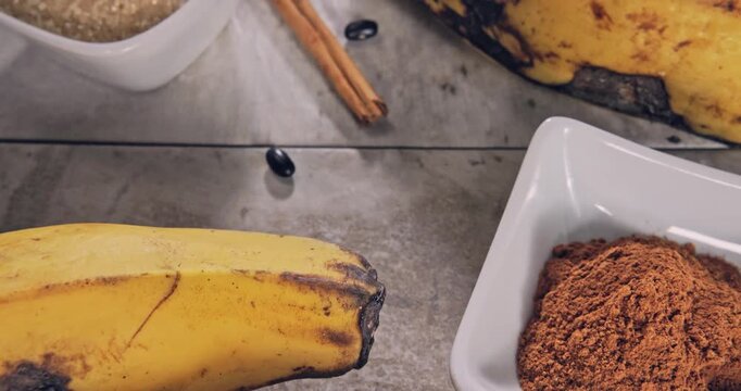 Top view, tour view of ripe bananas with ingredients on a natural surface.
