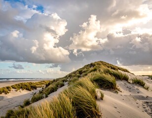 Sandy dune crests beneath a sky of dramatic, sunlit clouds meeting the distant shore, grassy textured slopes in bright sunlight