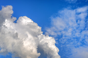 Dramatic deep blue sky with large fluffy white cumulus cloud formation