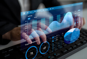 A professional man interacts with a futuristic touchscreen displaying interactive data visualizations in a modern office setting, enhancing productivity and analytics. Impute
