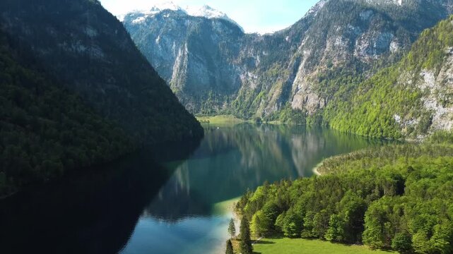 Wide aerial panorama of Lake K&ouml;nigssee surrounded by teep mountain slopes