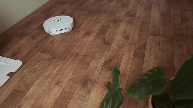 Robot helper mops the floor creating a clean and fresh atmosphere at home for comfortable living