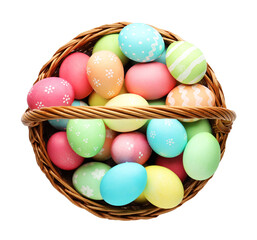Naklejka premium Painted Easter eggs in wicker basket isolated on white, top view