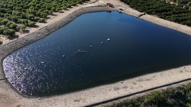 Aerial view of irrigation reservoir pond in agricultural farmland