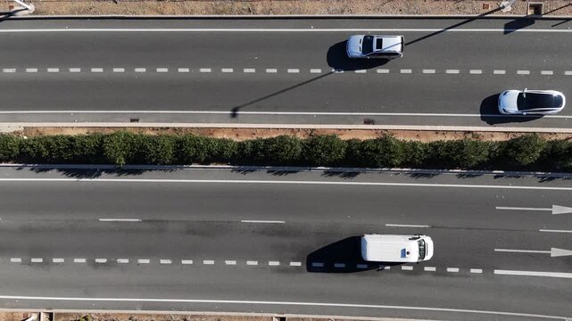 Top down aerial view of cars driving on multilane highway traffic