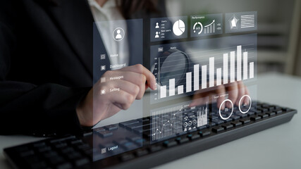 A business professional engages with a digital dashboard showcasing data visualization and performance metrics while working with a keyboard, indicating modern technology use. Impute