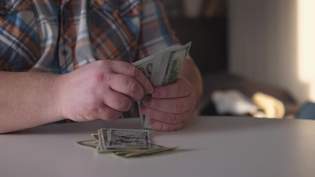 Man Sorting Cash Slowly, Person Carefully Categorizing Cash Notes In Relaxed Setting, Man Systematically Organizing His Savings While Enjoying Comfortable And Calm Environment
