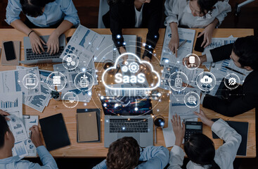 A diverse group of professionals collaborates in a meeting focused on analyzing cloud software solutions, discussing data and strategies for effective business outcomes. Trope