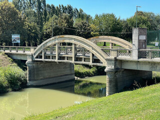 Fototapeta premium Old concrete bridge in a rural area, Ferrara, Italy