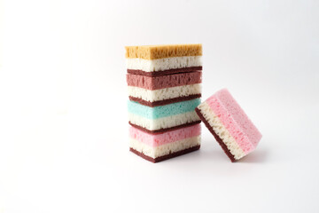 Colorful layered sponges for industrial cleaning company or retail marketing. Minimalist composition for janitorial services, product catalog, sanitary supplies, and domestic organization brands.