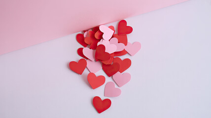 Scattered hearts on pink and white background