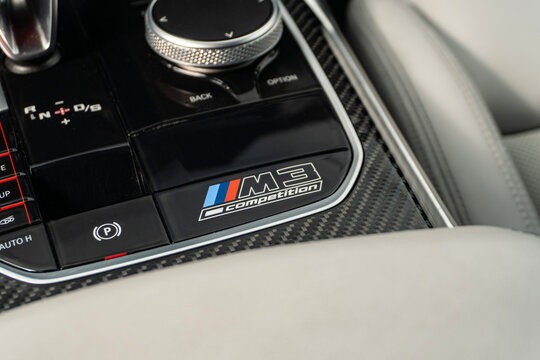 BMW M3 Competition center console badge and controller, Luxury car carbon fiber interior trim detail