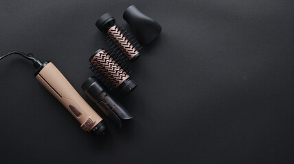 Styling tool with interchangeable attachments for versatile hair styling options