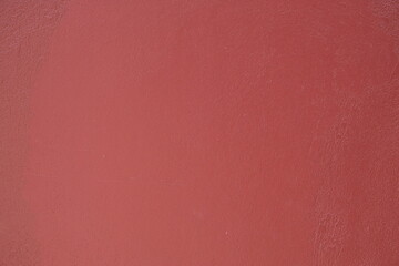 Fototapeta premium Close-up texture of a smooth, matte, dusty rose colored surface with subtle imperfections