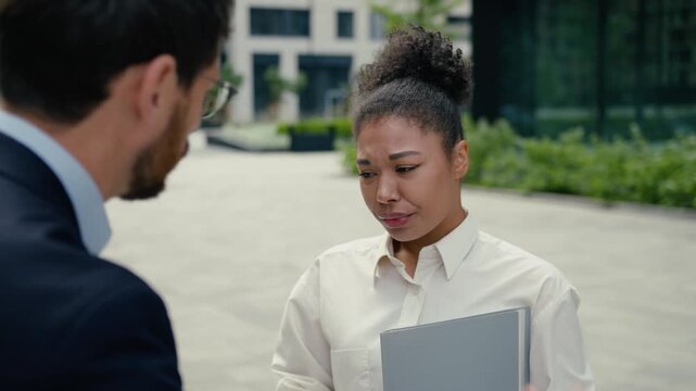 Angry Caucasian businessman boss scolding African businesswoman at work stressed intern crying upset manager authority aggressive talk bad conflict office laptop job problem corporate stress deadline
