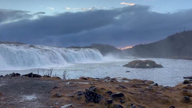 Waterfall Faxi at Winter Sunset with Cloudy Sky, Iceland.