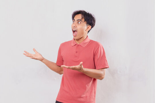 young adult man looking to the side with a funny shocked facial expression. Isolated on white background, expressing surprise, humor, amazement, and unexpected reaction